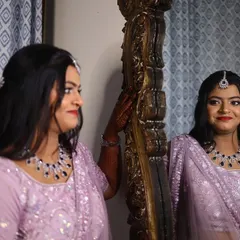 My beautiful bride Isha Rao, admiring her final reception look. I created a soft glam style with a bold berry lip to perfectly match her lavender lehenga and diamond jewelry.