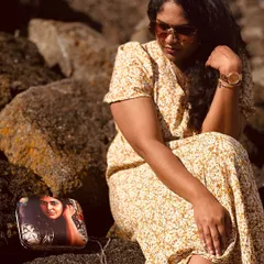 A quiet moment with a cherished memory. This image beautifully captures a customer with her personalized photo clutch. It’s more than an accessory; it’s a story you carry with you.