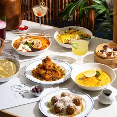 A table filled with a variety of dishes from Bali Boo. This kind of top-down shot is great for giving customers a full overview of the menu's offerings.