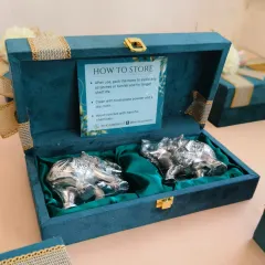 The interior of the suede box, featuring two German silver elephants nestled in rich green satin. I also included a "How to Store" card to add value and ensure the longevity of the gift.