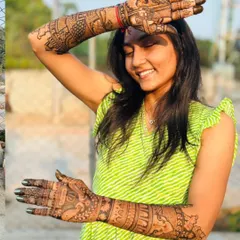 A candid shot of a happy bride enjoying her beautiful, dark-stained mehendi outdoors. I use only natural henna for the best color.