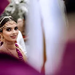 A beautiful candid shot of the bride. Her smokey eye makeup adds a touch of modern drama to her traditional wedding look, creating a captivating and memorable style.