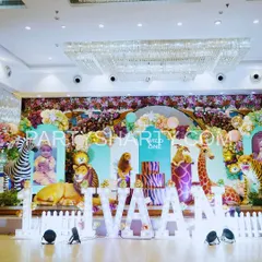 We create immersive jungle and safari adventures with lifelike 3D animal props and lush, layered backdrops. This 'Wild One' stage setup shows our ability to transform a venue into a vibrant wilderness, perfect for a little explorer's first birthday.