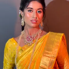 A close-up of the Haldi bride, showcasing her flawless, dewy skin and the intricate details of her traditional jewelry.