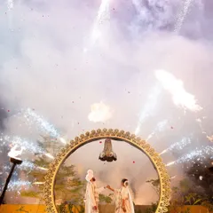 A spectacular varmala moment captured under a sky of fireworks. This is the kind of grand, 'wow' shot I live for, freezing a moment of pure celebration and magic that you will remember forever.