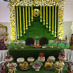 A complete Seemantha decor package. This setup includes a beautiful floral backdrop, a decorated throne chair, and an array of traditional offering plates (Aarthi plates) arranged artfully.
