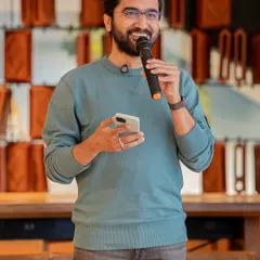 The joy of sharing your story. A performer's smile lights up the room at one of our Sunday open mic sessions, capturing the supportive and encouraging atmosphere we cherish.