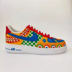 A side view of the custom mismatched Indian art sneakers. You can see how the different patterns, from floral motifs to geometric checks, come together. I love playing with primary colours to make the designs pop.