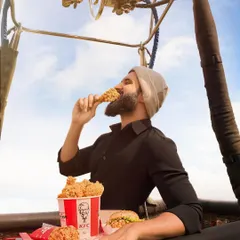 Up in the air for a KFC campaign with Vijay Deverakonda. The styling is simple and dark to make the iconic red KFC bucket pop, keeping the focus entirely on the product.