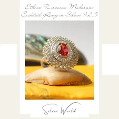 Our ethnic Zirconia Maharani cocktail ring is designed to command attention. It features a central red stone surrounded by multiple layers of sparkling zirconia, fit for royalty.