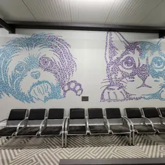 This large-scale wall art for Chasing Tails, a pet care facility, was made by assembling hundreds of small, custom-cut MDF pieces. The technique creates a unique pixelated or pointillist effect, perfect for detailed graphics.
