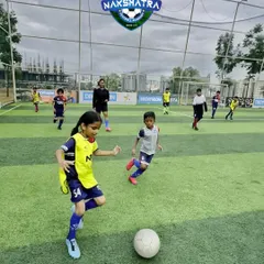 Every goal begins with belief. A young girl in our grassroots program dribbles the ball with confidence, ready to take on the opposition.