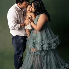 Wrapped in love. This tender moment between parents and their baby girl is what family photography is all about. It's a story of connection, captured forever.