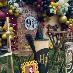 A closer view of the Harry Potter props, including a broomstick, sorting hat, and a framed photo of a character.