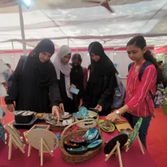 A group of young women curiously exploring the art and crafts at my stall. Events like these are a great way to inspire the next generation of artists and makers.