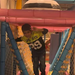 Making his way through the soft play obstacle course. These structures are designed to be challenging but safe, helping kids build confidence as they explore.