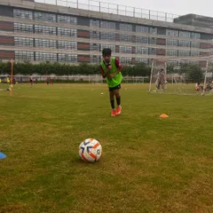 A young player preparing to strike the ball during a training session. Passion is the fuel for every dream.