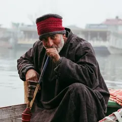 A portrait of a Kashmiri man enjoying his hookah on a boat. Capturing the faces and traditions of a place is just as important as capturing its landscapes.