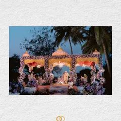 A beautifully framed shot of the wedding mandap in Goa, set against the evening sky, hinting at the grandeur and romance of the ceremony to come.