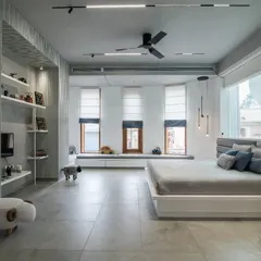 A minimalist bedroom designed for kids, featuring a clean grey and white palette, ample natural light from bay windows, and playful sheep-themed stools. The space is designed to be both calming and inspiring for creativity.