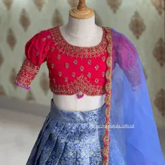 A close-up of the embroidered blouse for the kids' lehenga set. The puff sleeves and delicate butis are perfect for a young girl.