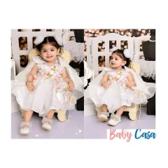 A little angel in her butterfly-themed party dress. This white gown features delicate 3D butterflies and a beautiful cape, making it a whimsical and elegant choice for a birthday or special event.