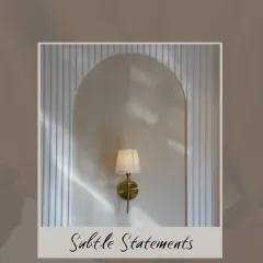 Subtle statements can make the biggest impact. A simple, elegant wall sconce set in an arched niche with a textured backdrop creates a feeling of peace and luxury.