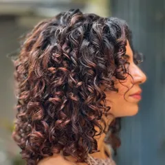 After: With a no-bleach balayage and a fresh curly cut, the new color brings out the beautiful shape and definition of every single curl.