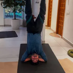 An inversion pose using the aerial hammock, which helps decompress the spine and improve circulation. This student demonstrates strength and trust as he comfortably hangs upside down.