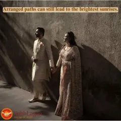 A couple holds hands, standing together against a wall as sunlight streams in. This artistic shot symbolizes that even arranged paths can lead to the brightest future.