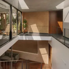 The interior of the Debris Block House in Bangalore, showing how a subtle shift in the multi-level staircase allows light from skylights to reach the ground floor. The walls are made from debris blocks, an example of our commitment to sustainable and honest materials.