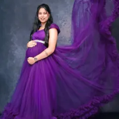 The same 'flying trail' effect, captured in a studio setting. This purple gown with its ruffled trail creates a dynamic and artistic shot against a simple, textured backdrop.
