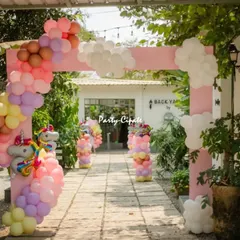 A grand entrance arch for a unicorn party. The combination of the pink structure and the pastel rainbow balloon garland created a perfect welcome.