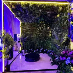 We even make photo booths fun and stylish. This 360-degree revolving camera is set within a lush green backdrop, framed by neon lights for a modern, interactive experience. 💜🌸