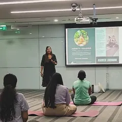Presenting on wellness topics during a corporate session at ABB. My programs often include educational components on topics like posture, mindfulness, and stress management.
