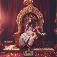 Embodying the spirit of the goddess, this mother-to-be exudes strength and grace, a true reflection of Durga in a regal setting.