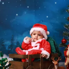 A close-up of our little Santa, capturing a curious and sweet expression. The soft, plush Santa suit and hat are part of the wardrobe I provide for my festive holiday sessions.