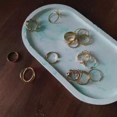 My oval ceramic trinket tray in a beautiful seafoam green marble finish, styled as a perfect organizer for your favorite rings and jewelry.