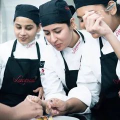 Students gathered around, learning the finer points of a classic recipe. Our small class sizes ensure everyone gets a close look and personalized guidance.