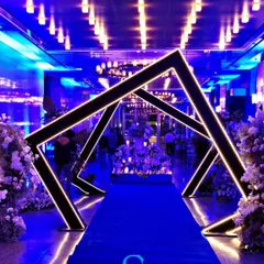 We love creating modern, high-impact designs for cocktail parties and corporate mixers. This geometric entrance tunnel, lit with a cool blue glow, provided a futuristic and exciting pathway for guests, setting a vibrant mood from the moment they arrived.
