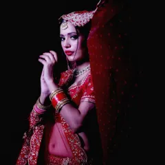 This portrait focuses on the bride's pose and the flow of her traditional attire. It's a great example of a creative studio shoot, playing with shadows and form to create a striking image.