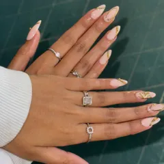 Get a closer look at this elegant nail set. I've crafted these long, almond-shaped extensions with a soft nude base and finished them with delicate gold foil accents. It's a perfect example of custom nail art that's both classy and on-trend.