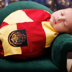 A serene close-up of a sleeping newborn in our Harry Potter theme. The focus is on the baby's peaceful expression, making it a timeless magical portrait.