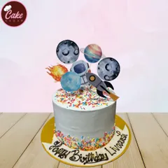 An out-of-this-world galaxy theme cake. This design is decorated with edible planets, an astronaut, and a rocket ship, perfect for a space enthusiast's birthday.