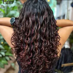 We call this our hot cocoa look. These warm, autumnal red and copper tones were created without any bleach, perfect for adding a cozy vibe to curly hair.