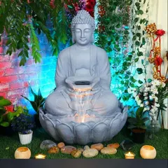 A beautiful Buddha water fountain, perfect for creating a zen corner in your garden. The gentle flow of water, combined with the serene statue and surrounding plants, provides a focal point for meditation and relaxation.