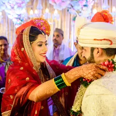 The Varmala exchange during the Mangalashtaka. Shruti's smile as she garlands Aakash is just beautiful. This is a key moment in a Maharashtrian wedding, full of joy and surrounded by family.