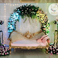 Another view of the stunning engagement floral arch, showing the detail of the flower arrangement and the soft, romantic lighting.