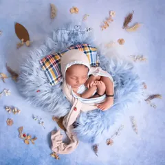 Sleeping on a cloud of blue fur. This minimalist setup uses texture and a simple color palette to create a dreamy and serene atmosphere.