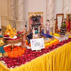 Our baby shower rukhwat setups begin with an auspicious Ganesha idol, surrounded by fresh flowers and dolls ready to welcome the new arrival. The Marathi sign expresses blessings for the mother-to-be.